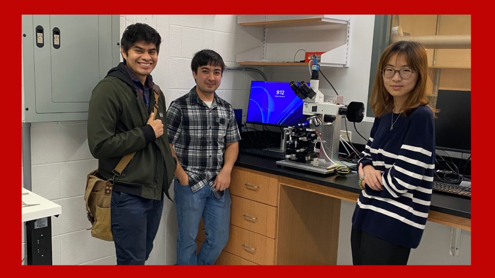 Juan Siliezar (left) tours the Kuehne Lab with Ph.D. students Jacob Bair and Chuye Peng